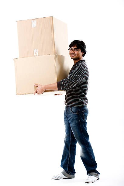 Student carrying two large boxes