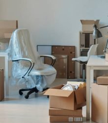 Horizontal image of big light office with new furniture and unpacked cardboard boxes